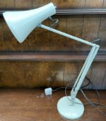 A cream anglepoise lamp on a weighted base