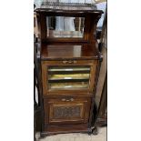 An Edwardian walnut music cabinet, with a three quarter gallery, mirrored back,