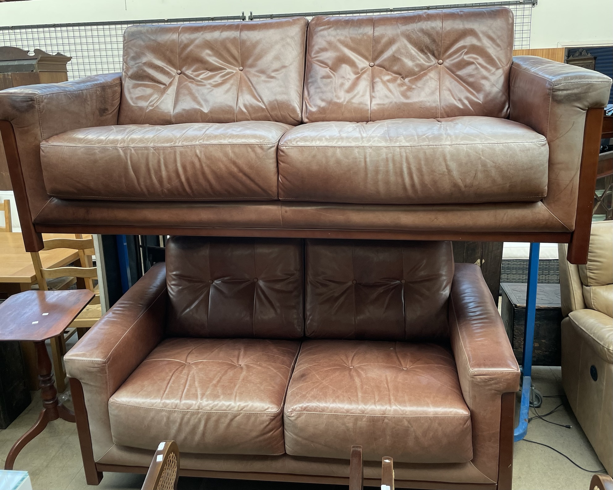 A brown leather Sofitalia three seater settee together with a matching two seater settee