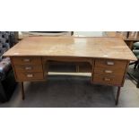 A mid 20th century Danish teak desk, designed by Svend & Madsenwith with arched legs, 150.