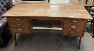 A mid 20th century Danish teak desk, designed by Svend & Madsenwith with arched legs, 150.