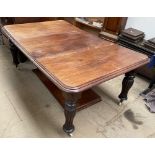 A Victorian mahogany extending dining table with a rectangular top with rounded corners on reeded