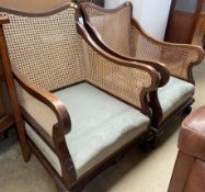 A pair of bergere arm chairs with caned arms and back
