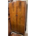 A 20th century walnut wardrobe together with a 20th century mahogany side cabinet and a serpentine