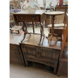 A 20th century oak side cabinet with a pair of cupboard doors and a drawer on shaped legs together