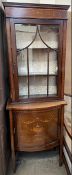 An Edwardian mahogany display cabinet, with a moulded cornice and a glazed door with glazed sides,