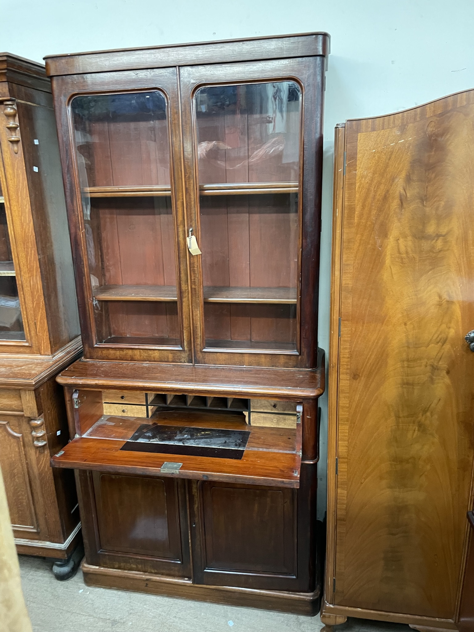 A Victorian mahogany secretaire bookcase, the cornice above a pair of glazed doors,