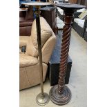 A mahogany torchere with a dished top above a barley twist column on a circular foot together with