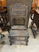 An 18th century oak chair with a carved pad and planked seat