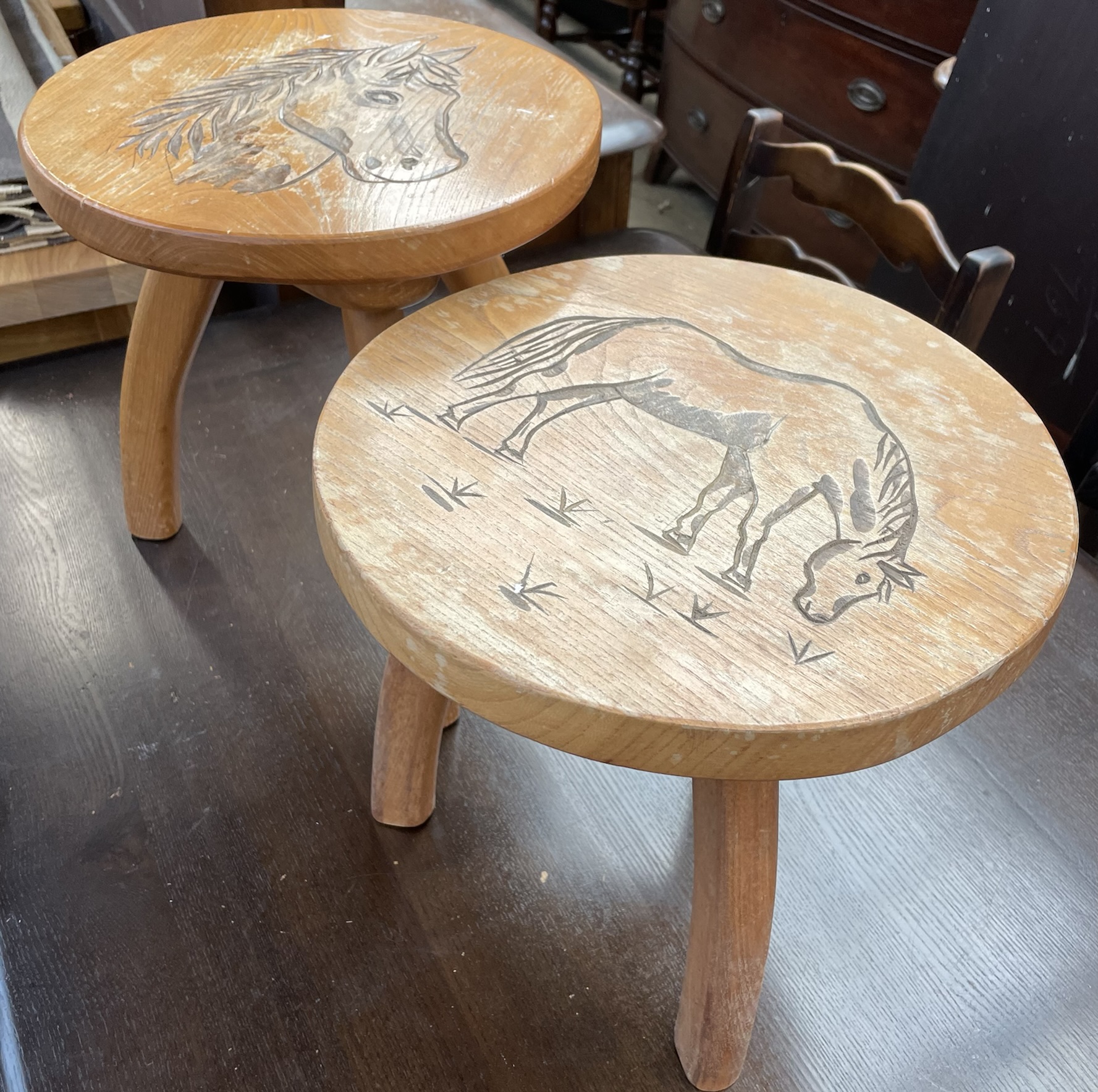 A pair of three legged stools,