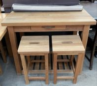 An oak breakfast bat with a rectangular top and frieze drawer together with a pair of bar stools