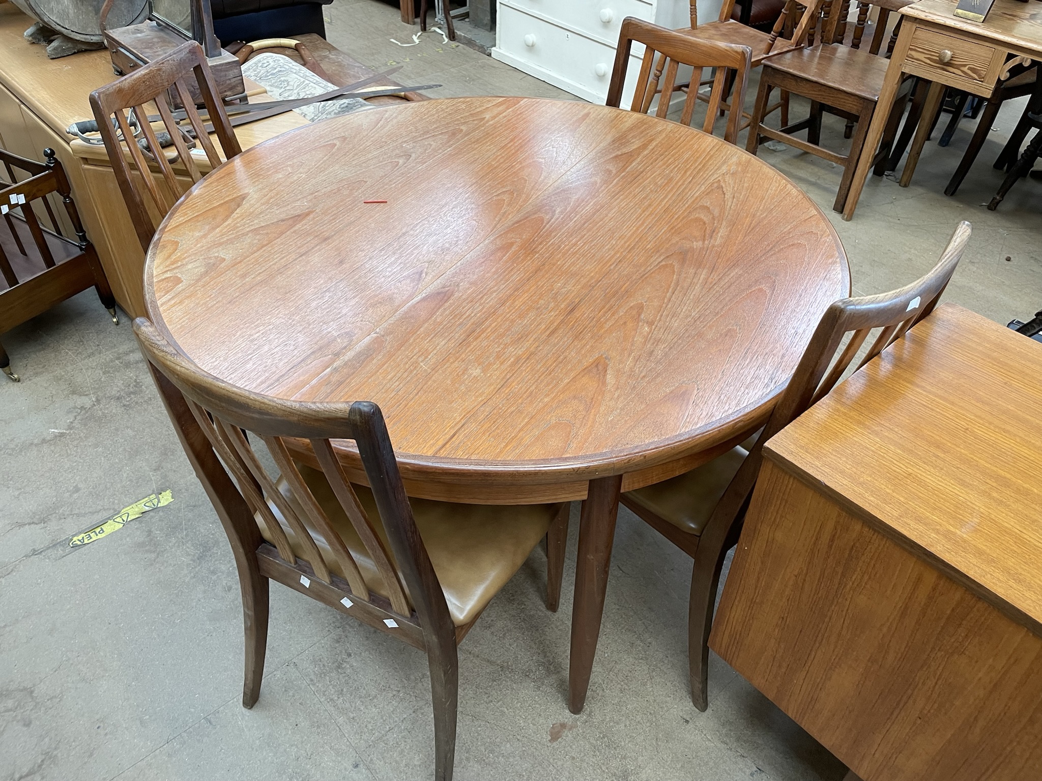 A mid 20th century teak dining suite comprising a circular extending dining table four chairs and a - Image 2 of 3