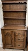 A 20th century dresser with a moulded cornice above shelves,