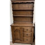 A 20th century dresser with a moulded cornice above shelves,