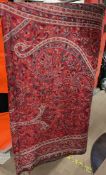 A large wool paisley shawl in reds and blues