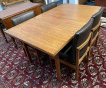 A mid 20th century teak extending dining table and four chairs