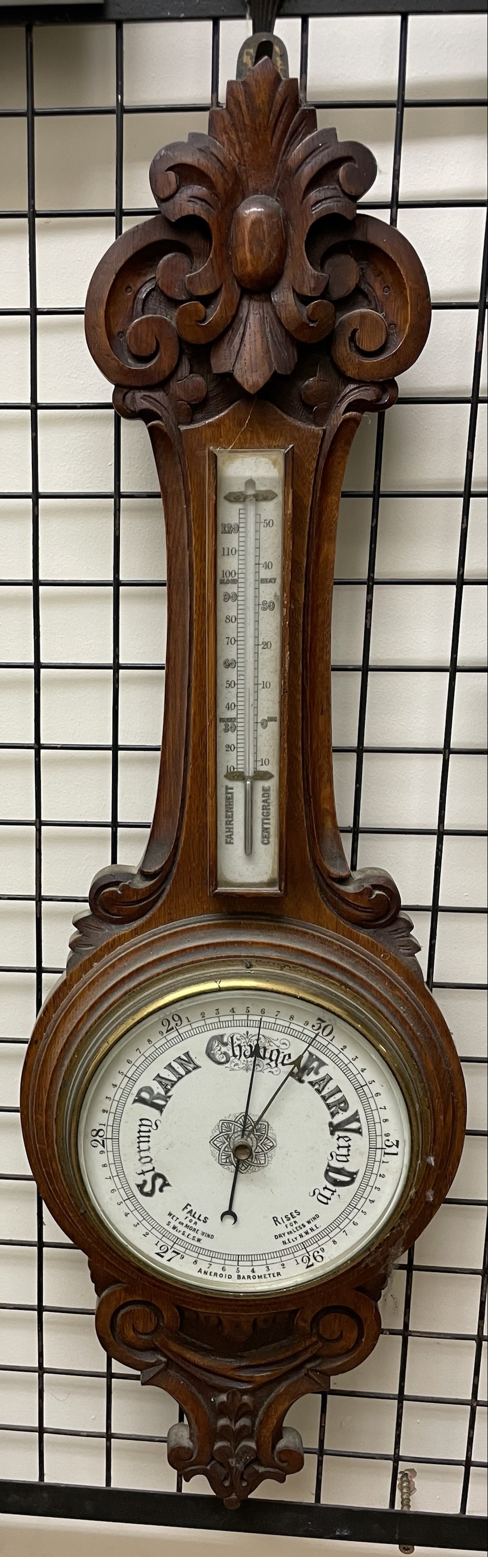 An oak cased aneroid barometer with a mercury thermometer