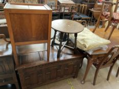 An oak coffer with a carved front together with a sewing cabinet,