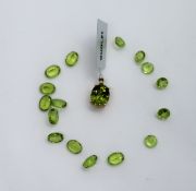 Gemporia - A red dragon peridot and white zircon 9k gold pendant together with ten oval brilliant