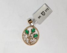 Gemporia - A Colombian emerald and white zircon 9k gold pendant set with three oval emeralds and