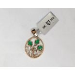 Gemporia - A Colombian emerald and white zircon 9k gold pendant set with three oval emeralds and