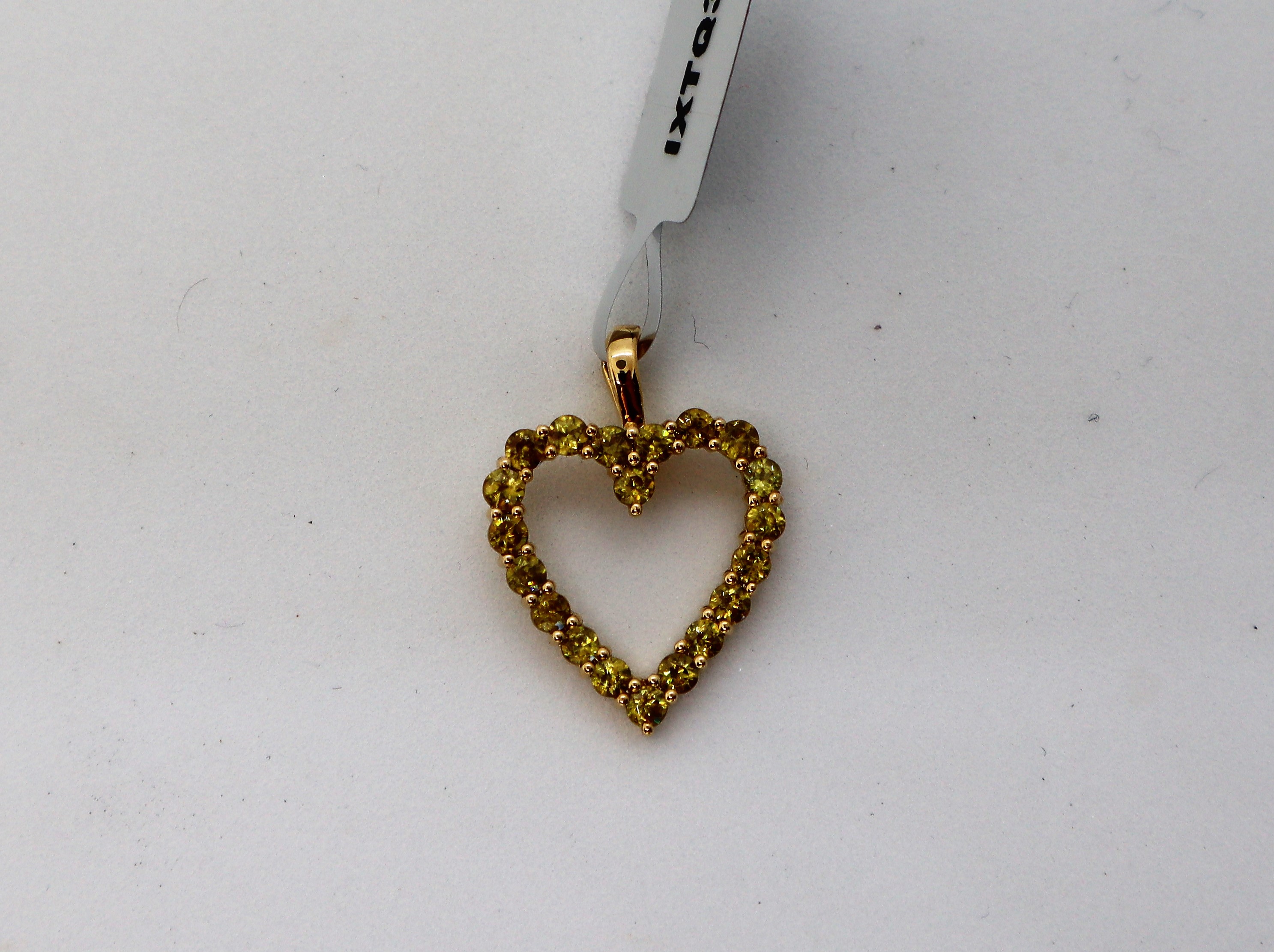 Gemporia - An ambilobe sphene 9k gold heart design pendant, set with twenty ambilobe sphene,
