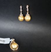 Gemporia - A pair of golden South sea cultured pearl and diamond 18k gold earrings set with