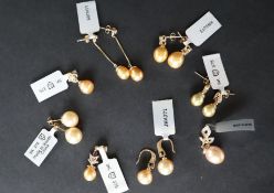 Gemporia - A pair of golden South sea cultured pearl and black spinel 9k gold earrings together