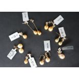 Gemporia - A pair of golden South sea cultured pearl and black spinel 9k gold earrings together