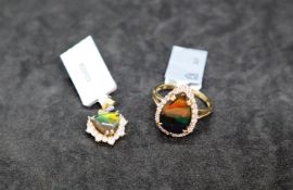 Gemporia - A pear shaped ammolite and white zircon 9k gold ring,