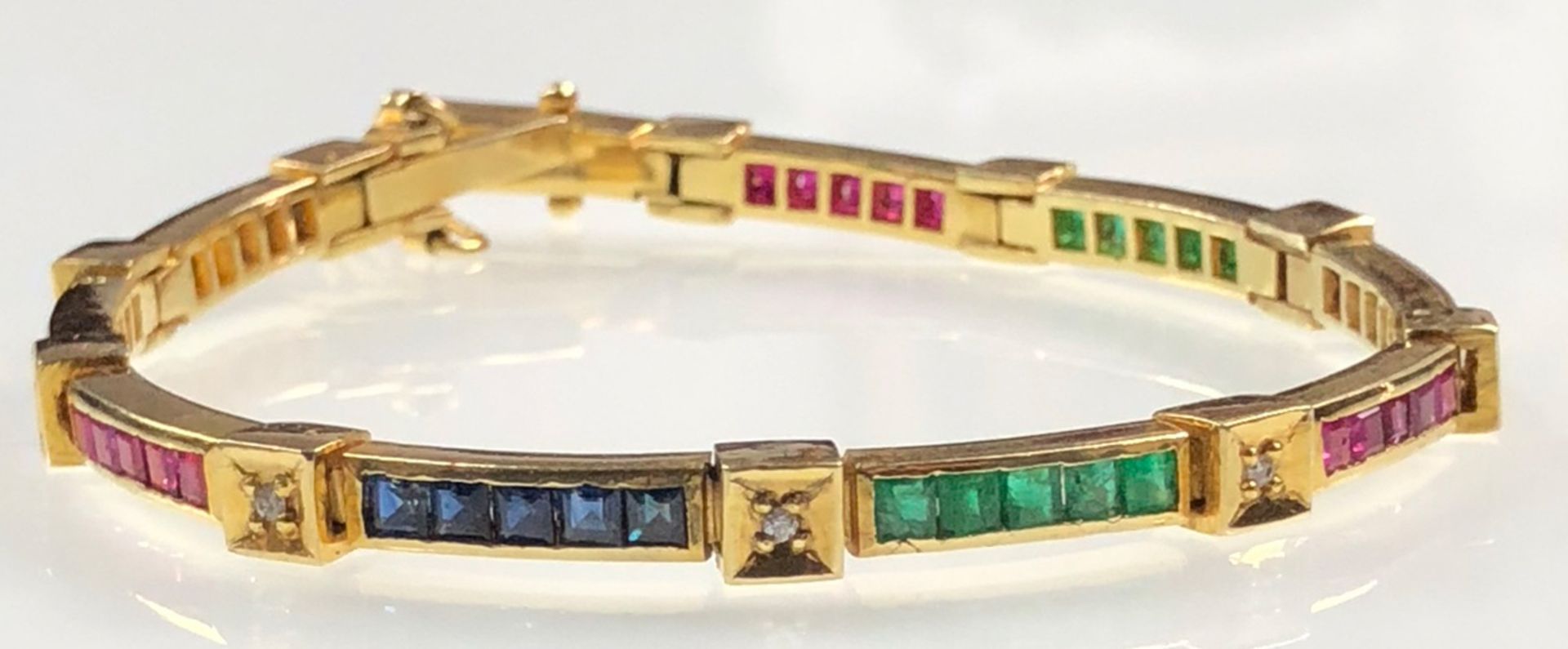 Yellow gold bracelet. Tested 18 carat. Diamonds, sapphires and rubies.