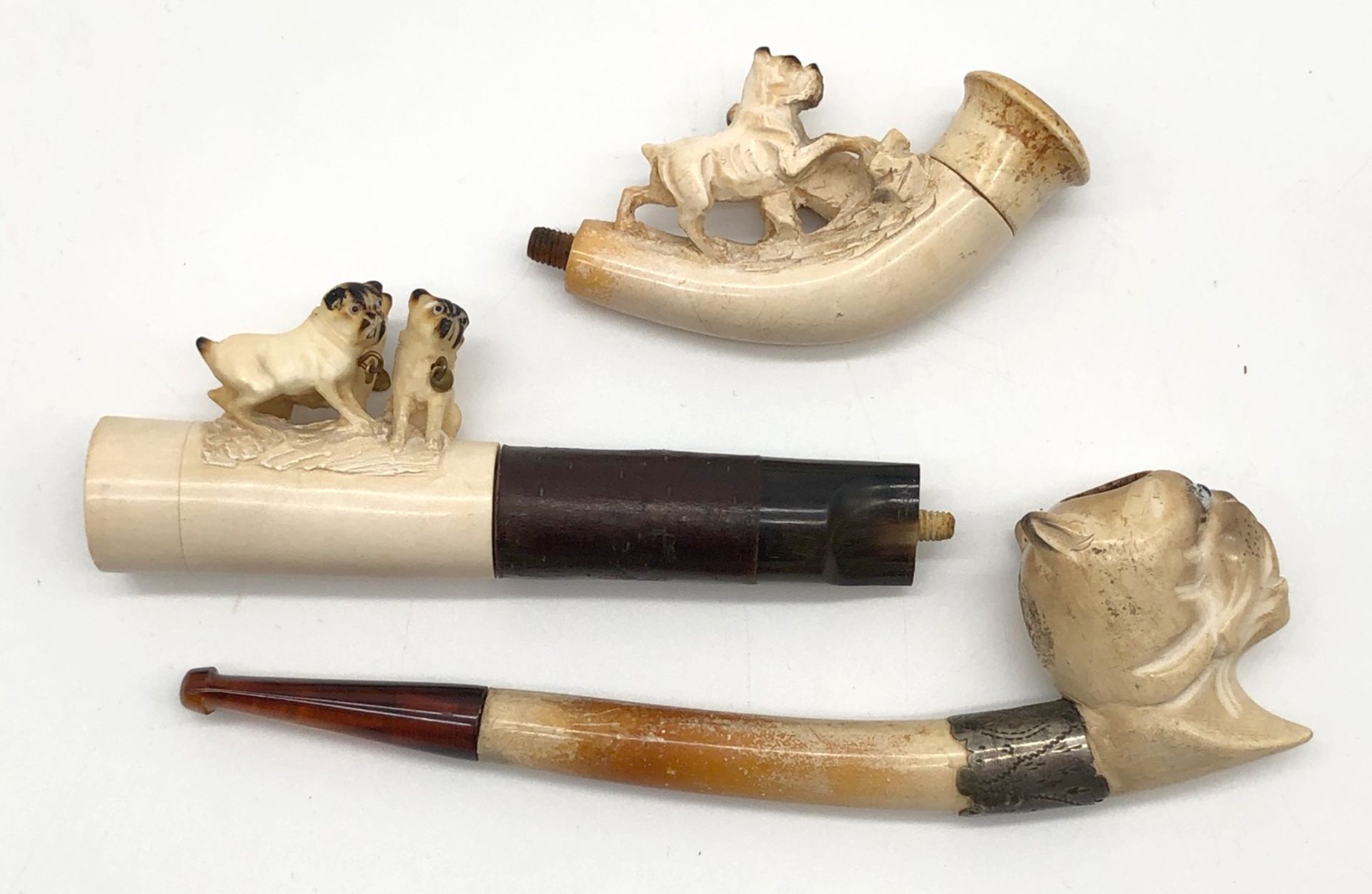 3 meerschaum pipes with pug. One with a case. Probably 120 - 180 years old