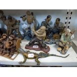 Five Chinese partially glazed pottery figurines including tennis players, a fisherman and a warrior,