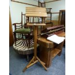 A wooden floor standing bird feeder modelled as a cottage [room]