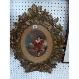 An antique carved and gilt wood oval frame, decorated with garlands of leaves, fruits and flowers,