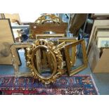 A collection of antique and vintage vacant picture frames, including gilt ovals with scrolling