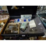 An attaché case containing coins and banknotes from around the world, including Mexico and Brazil,