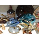 A shelf of decorative items, including a silvered and gilt bronze figure of a mounted Cossack signed