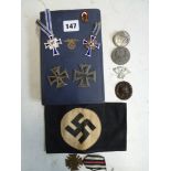 Nazi memorabilia, including two Iron crosses, other medals, an armband, badges, and a 1934 copy