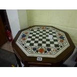 A very elaborate octagonal chessboard in Indian marble framed in inlaid hardstone of floral design