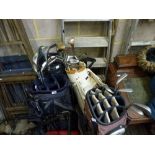 Four golf bags containing golf sticks by Yonex, Bigezee, Mizina and Bobby Locke plus a folding