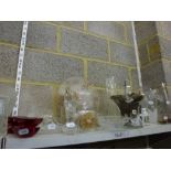 Two shelves of glass and other wares including a Quran stand, etched glass vases, fruit bowls,