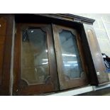 A charming Victorian oak cabinet of two glazed doors flanked by cupboards with inlaid decoration. [