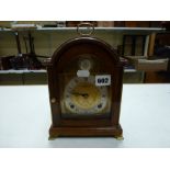 An Elliott reproduction small clock, retailed by Carrington & Co., half-hour striking on a bell,