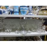 A shelf and a half of mixed glass comprising two large cut glass vases, a set of six cut glass