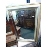 A modern rectangular wall mirror in a moulded silvered frame. TO BID ON THIS LOT AND FOR VIEWING