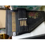 A vintage Auto-Harp, ebonised and with floral decoration [C] TO BID ON THIS LOT AND FOR VIEWING