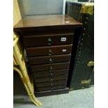 A small hardwood cabinet of eight shallow drawers. TO BID ON THIS LOT AND FOR VIEWING APPOINTMENTS
