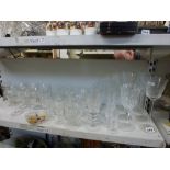 A shelf of glassware including dessert bowls, brandy balloons, wine glasses and sherry glasses along