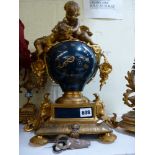 A late 19th century French mantel clock in good-quality gilt spelter and blue paint, surmounted by
